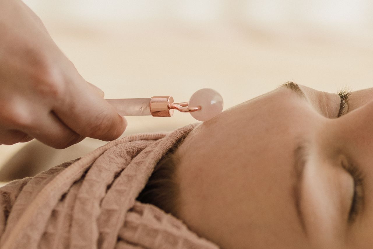 Close-up of a jade roller massage during a facial spa treatment, promoting relaxation and skincare.